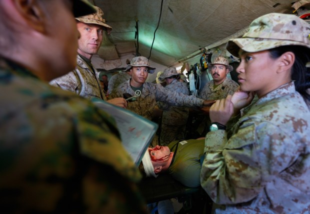 At Camp Pendleton, Navy medical personnel respond to a simulated attack by multiple drones that struck while troops were having chow at their forward base.  The wounded are immediately treated by medical personnel from the U.S. Navy and then given additional deteriorating medical symptoms from an evaluator, for the team to treat and diagnose.  (Nelvin C. Cepeda / The San Diego Union-Tribune)