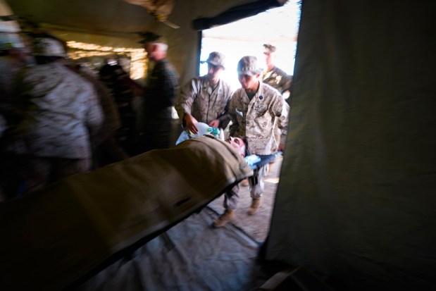 At Camp Pendleton, Navy medical personnel respond to a simulated attack by multiple drones that struck while troops were having chow at their forward base.  The wounded are immediately taken to a field medical unit comprised of medical personnel from the U.S. Navy, where they are treated and stabilized before being airlifted to a hospital. (Nelvin C. Cepeda / The San Diego Union-Tribune)