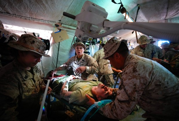 At Camp Pendleton, Navy medical personnel respond to a simulated attack by multiple drones that struck while troops were having chow at their forward base.  The wounded are immediately taken to a field medical unit comprised of medical personnel from the U.S. Navy, where they are treated and stabilized before being airlifted to a hospital. (Nelvin C. Cepeda / The San Diego Union-Tribune)