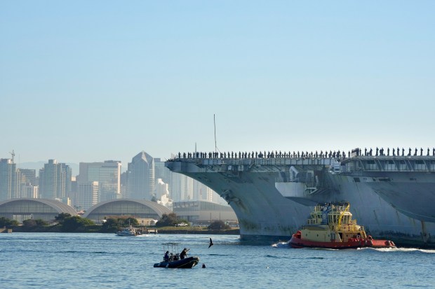 The USS Nimitz (CVN-68) makes her way into San Diego Bay mid-morning on Sunday, Dec. 7, 2025, in San Diego, CA. The Nimitz, which was ported in San Diego for 11 years, is finishing a 50-year service life and will be decommissioned next year. (Nelvin C. Cepeda / The San Diego Union-Tribune)