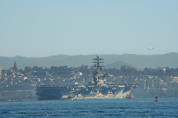 The USS Nimitz (CVN-68) makes her way into San Diego Bay mid-morning on Sunday, Dec. 7, 2025, in San Diego, CA. The Nimitz, which was ported in San Diego for 11 years, is finishing a 50-year service life and will be decommissioned next year. (Nelvin C. Cepeda / The San Diego Union-Tribune)