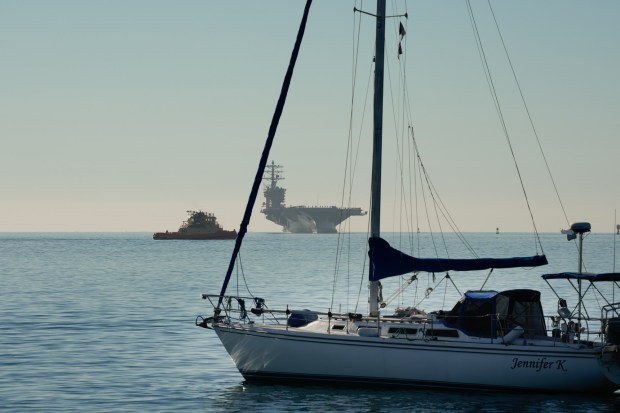 The USS Nimitz (CVN-68) makes her way into San Diego Bay mid-morning on Sunday, Dec. 7, 2025, in San Diego, CA. The Nimitz, which was ported in San Diego for 11 years, is finishing a 50-year service life and will be decommissioned next year. (Nelvin C. Cepeda / The San Diego Union-Tribune)