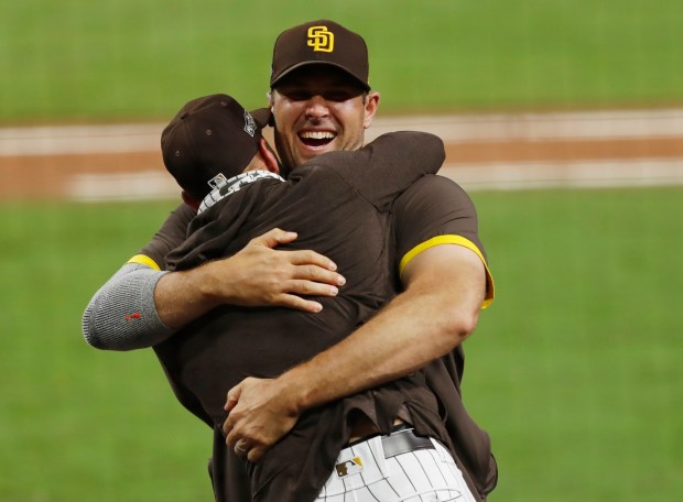 Padres relief pitcher Craig Stammen and manager Jayce Tingler celebrate after beating the Cardinals to win their Wild Card Series at Petco Park on Friday, Oct. 2, 2020. (K.C. Alfred / The San Diego Union-Tribune)