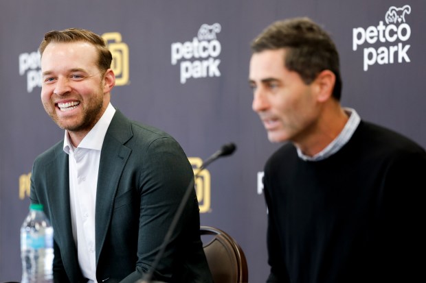Michael King, left, smiles during a news conference after the Padres re-signed him to a three-year, $75-million contract at Petco Park on Friday, Dec. 19, 2025 in San Diego, California. (Meg McLaughlin / The San Diego Union-Tribune)