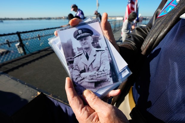 During the 84th Annual Pearl Harbor Remembrance Day Ceremony, David Harper, a volunteer on board the USS Midway Museum, shared an autographed photo of Admiral Chester Nimitz with his father, who was working as a civil service carpenter.  Harper was only 3 years old when he and his parents lived in Hawaii during the attack on Pearl Harbor.  (Nelvin C. Cepeda / The San Diego Union-Tribune)