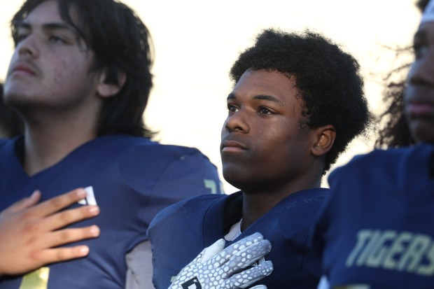 CHULA VISTA, CA - NOVEMBER 28, 2025: Morse's Superior Garror stands with teammates during the National Anthem before Morse plays against Hoover in the CIF Division 5 championship game at Southwestern College in Chula Vista on Friday, November 28, 2025. (Hayne Palmour IV / For The San Diego Union-Tribune)
