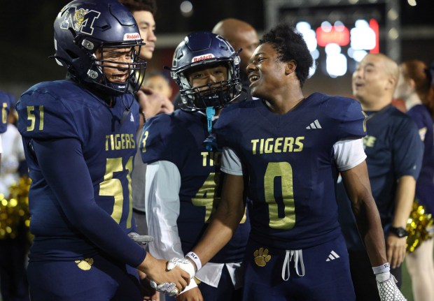 CHULA VISTA, CA - NOVEMBER 28, 2025: Morse's Superior Garror, right, celebrates with Jeremiah Llanes after Morse defeated Hoover 45-30 for the CIF Division 5 championship game at Southwestern College in Chula Vista on Friday, November 28, 2025. (Hayne Palmour IV / For The San Diego Union-Tribune)