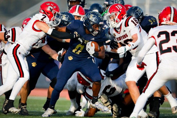 Morse's Superior Garror #0 runs the ball against Winters' Aidan Baylor #7 and Anthony Matamoros #18 during the Division 6-A State Championship at Buena Park High School on Saturday, Dec. 13, 2025 in Buena Park, California. (Meg McLaughlin / The San Diego Union-Tribune)