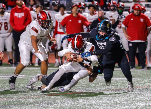 12/5/2025_Valley Center, CA_Prep Football, Division 6-AA Southern California championship, Moreno Valley Valley View at Valley Center- Valley View quarterback Michael Nuno gets sacked by Valley Center's Ramsey Molina, at right, and Mictch Stehly behind. (Charlie Neuman / For The San Diego Union-Tribune)