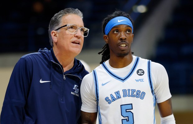 San Diego, CA - December 28:  Ty-Laur Johnson #5 of University of San Diego talks with coach Steve Lavin during a game against Pacific on December 28, 2025 in San Diego, CA.  (K.C. Alfred / The San Diego Union-Tribune)