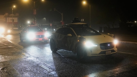 A Waymo vehicle sits idling at an intersection with no operating traffic lights due to power outages, in San Francisco, Saturday, Dec. 20, 2025. (AP Photo/Jeff Chiu)(AP)