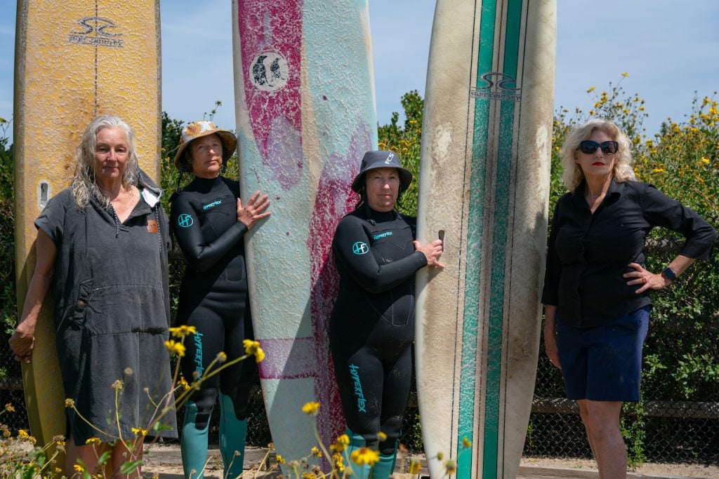 Women over-50 surfers at Santa Brabara's Wahine Kai Surf Club suited up in the parking lot