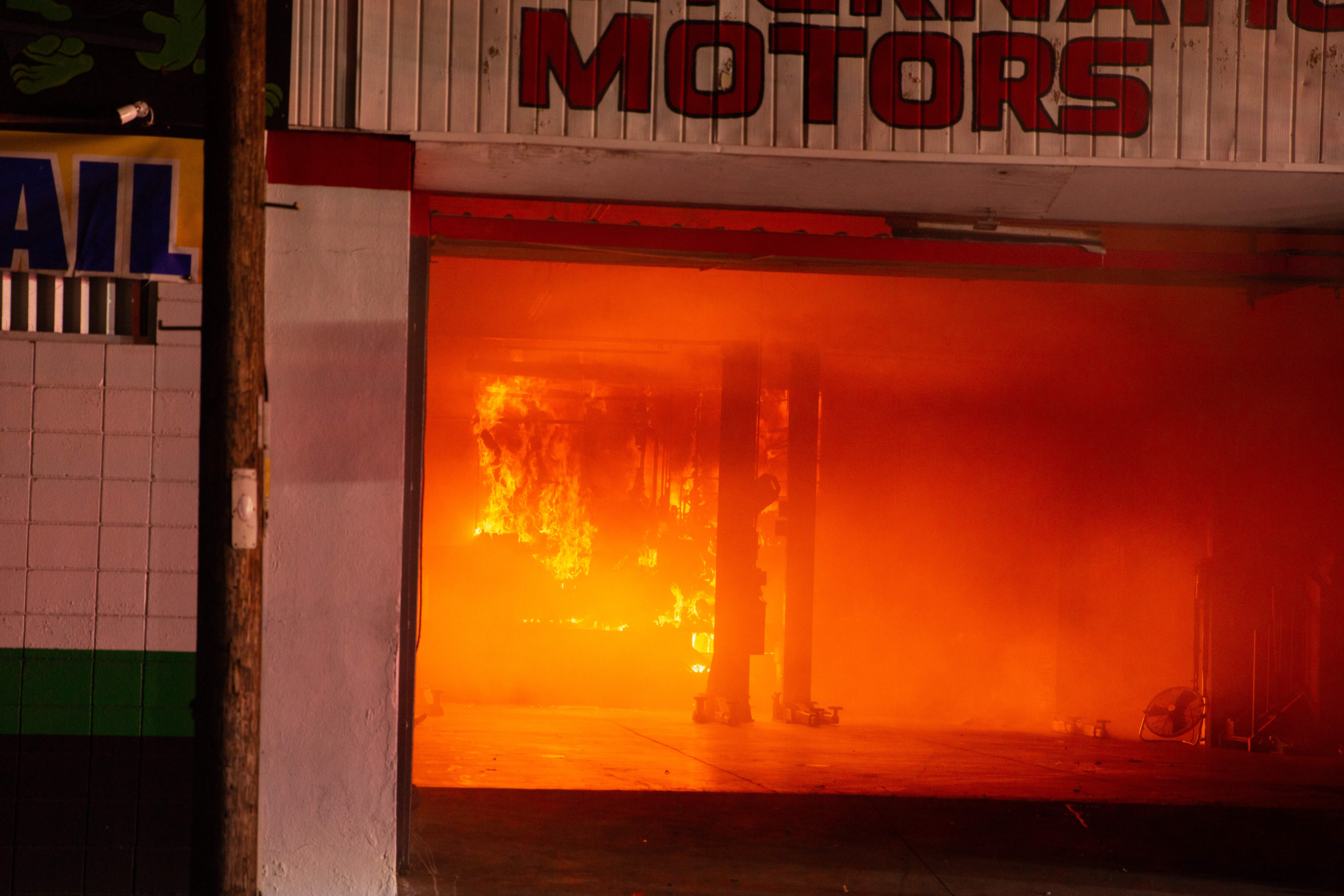Firefighters battle a blaze in The Bike Palace bicycle shop...