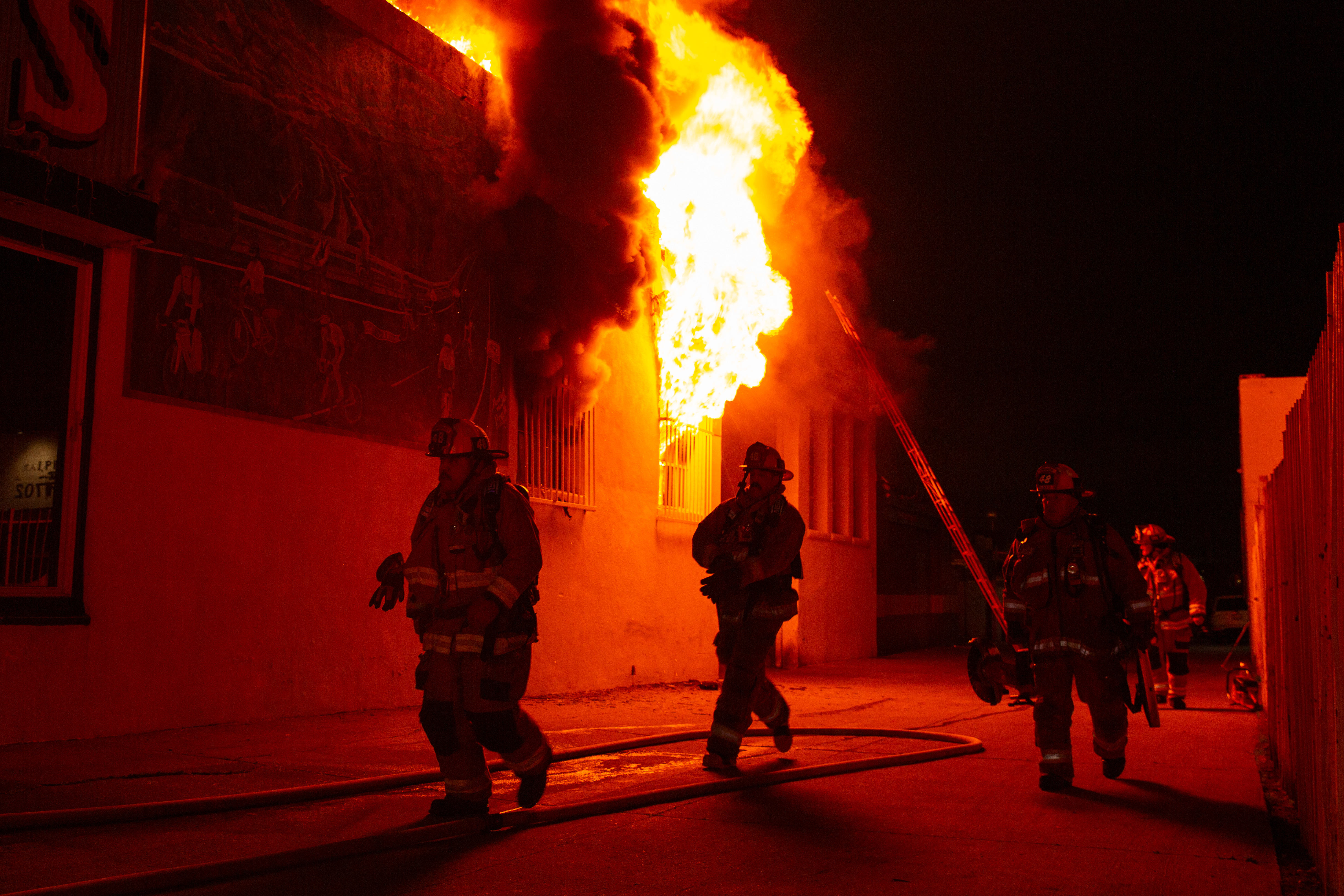 Firefighters battle a blaze in The Bike Palace bicycle shop...