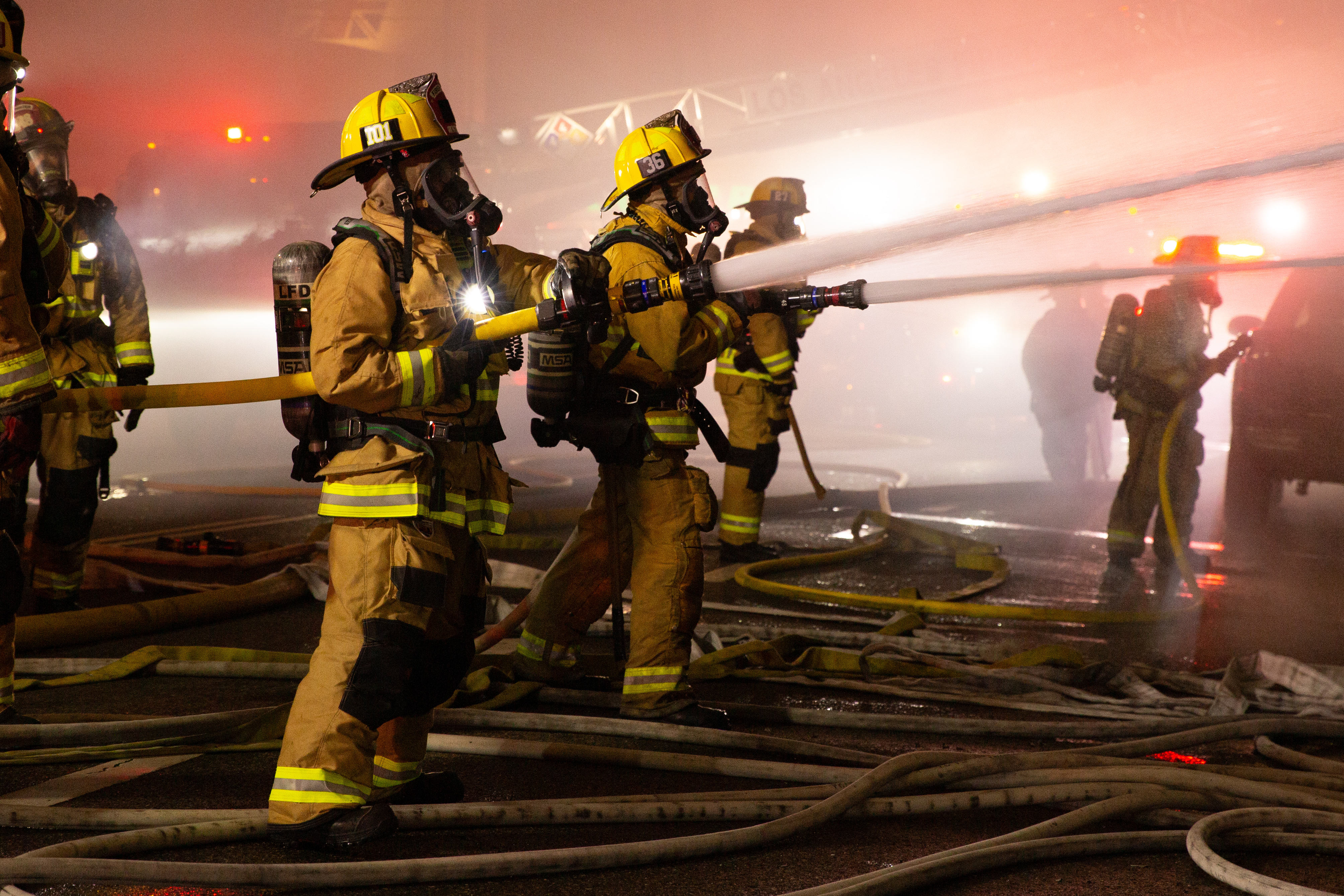 Firefighters battle a blaze in The Bike Palace bicycle shop...