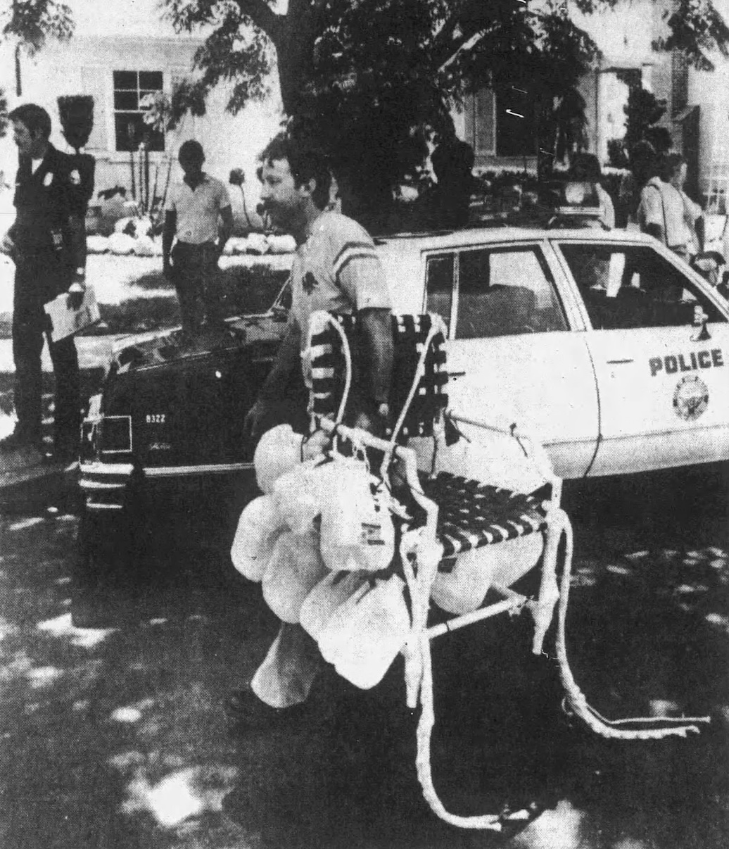 Larry Walters carries his lawn chair aircraft from his landing...