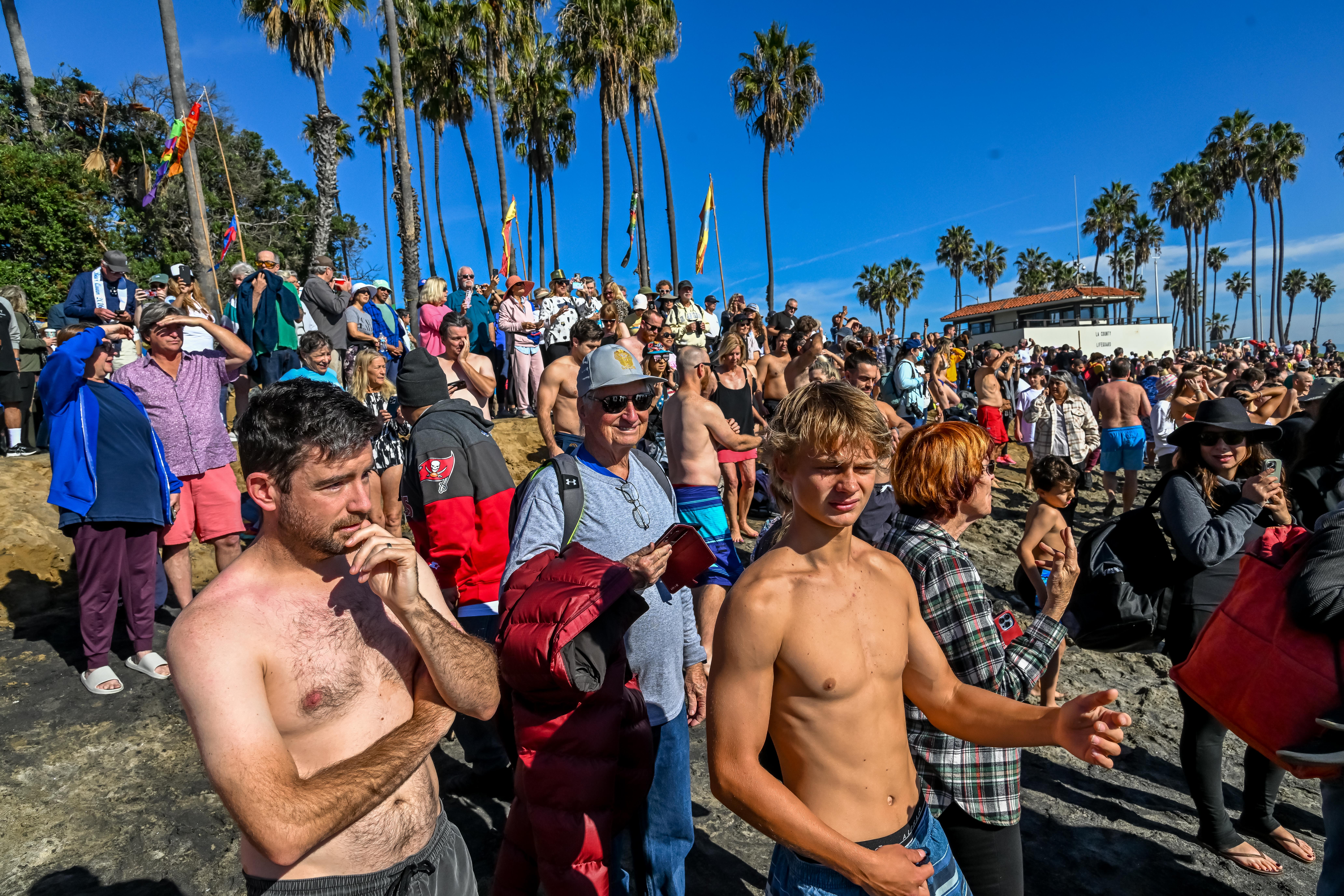 Hundreds gather to take a dip in the ocean to...