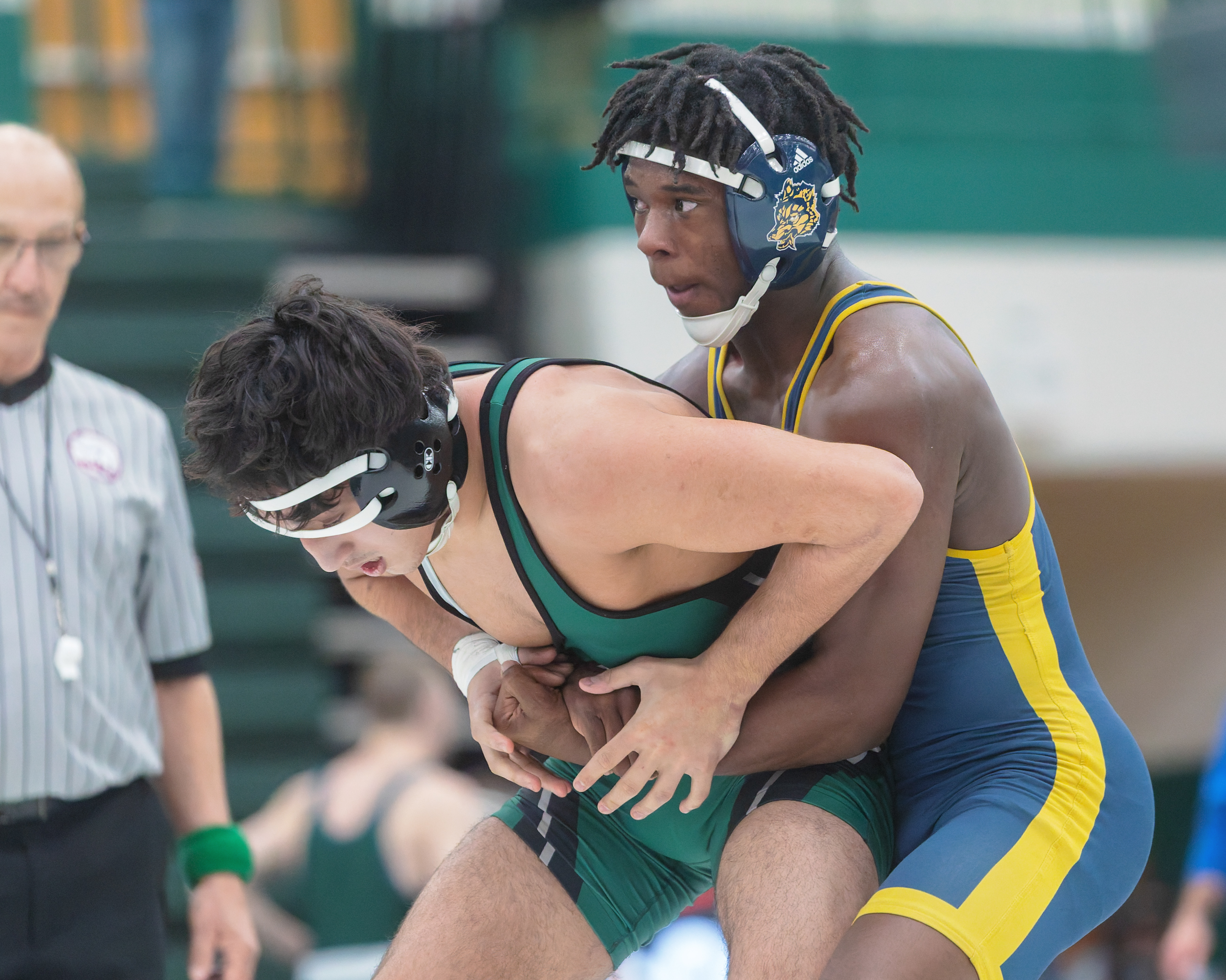 Clarkston's Nate Carter (left) defeated West Bloomfield's Christian Ausi 18-2...