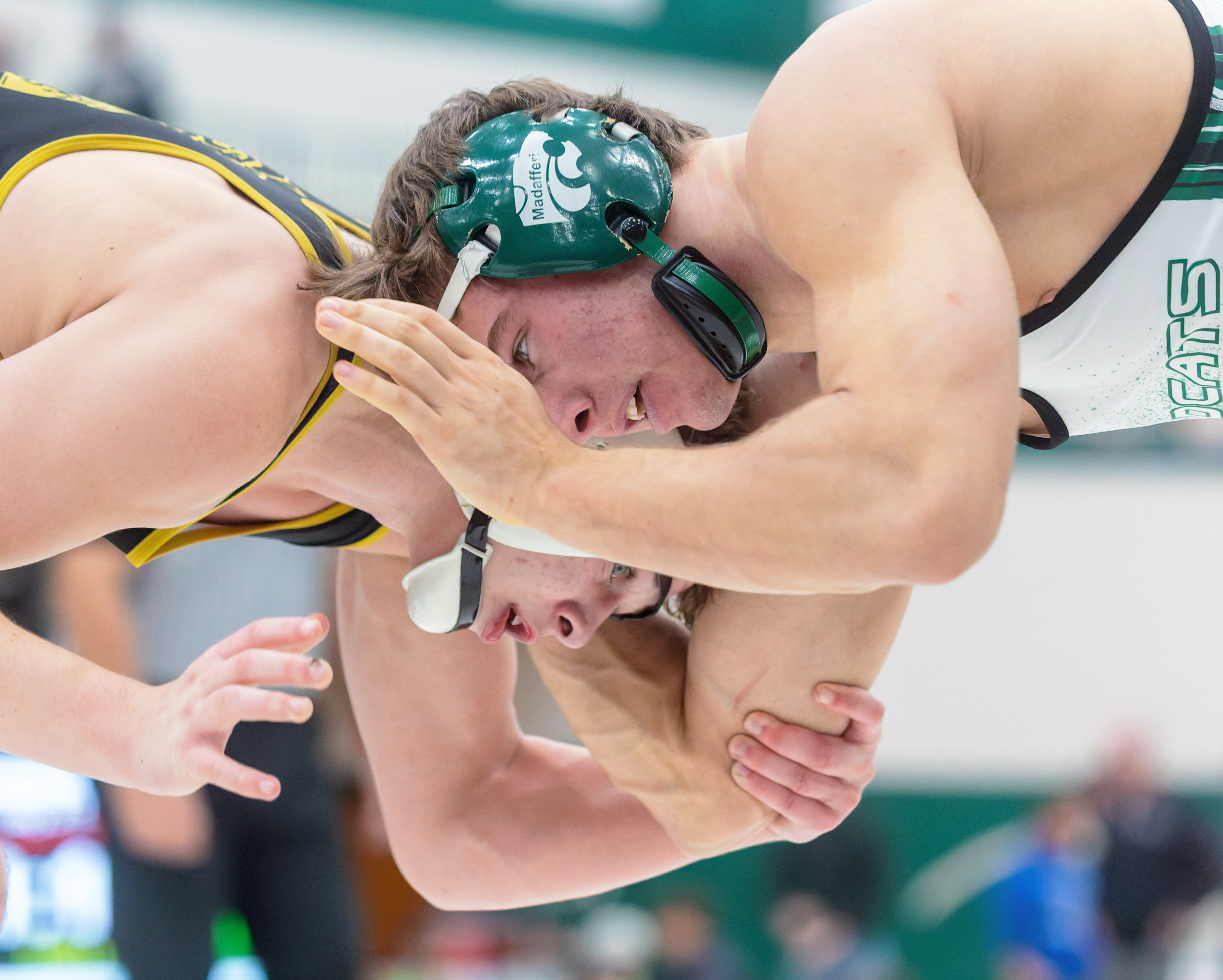 Clarkston's Ayden Mutter (left) defeated Novi's Anthony Madafferi 9-8 to...