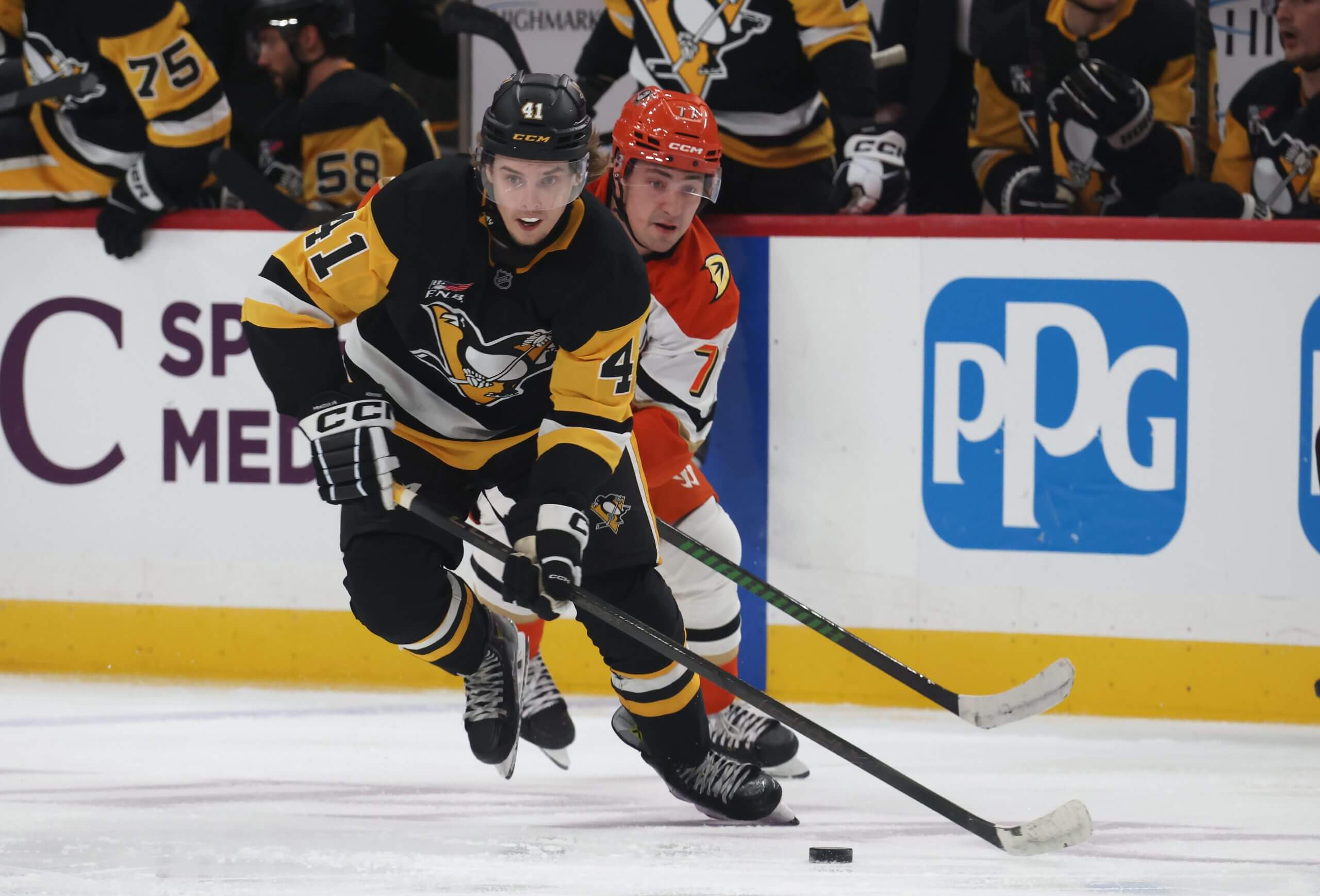 Ville Koivunen skates with the puck away with a Ducks player in hot pursuit.