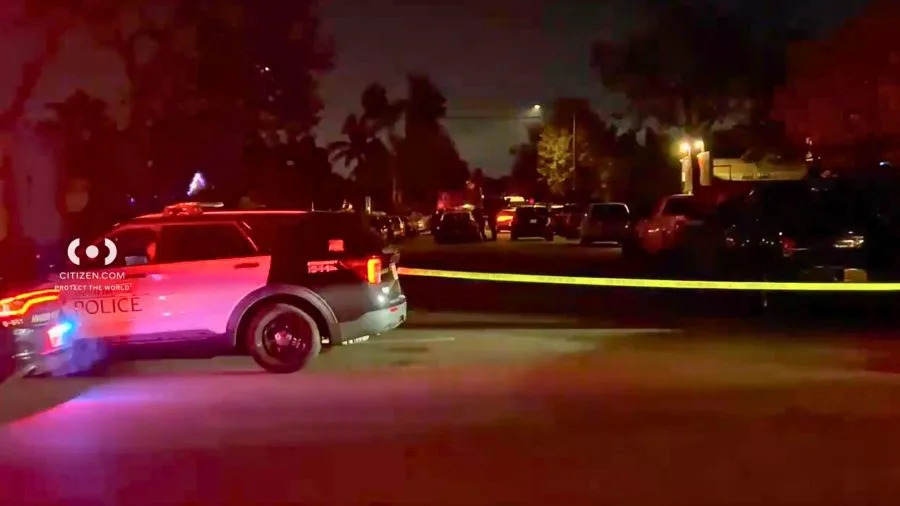Police vehicles and crime-scene tape block a residential street in Anaheim during an overnight officer-involved shooting investigation. December 2025. (Citizen.com)