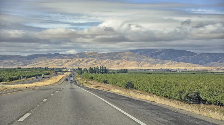 Highway 99 with mountain views, grass and trees