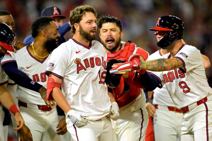 The Angels' Nolan Schanuel celebrates with teammates after a walk-off walk during the ninth inning against the Rangers.