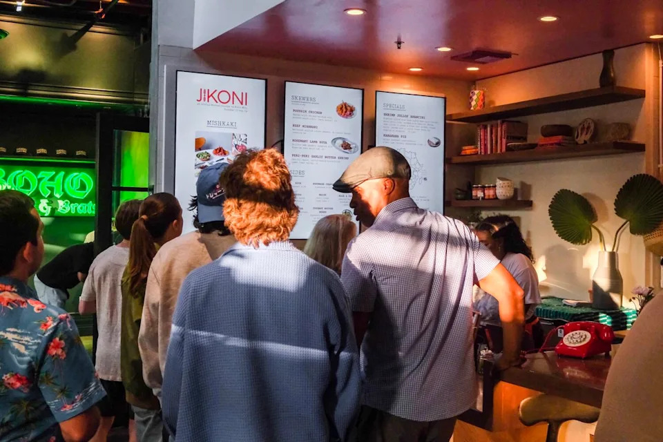 A crowd gathers to order at Jikoni, Kiano Moju's summertime pop-up inside Citizen Public Market in Culver City.