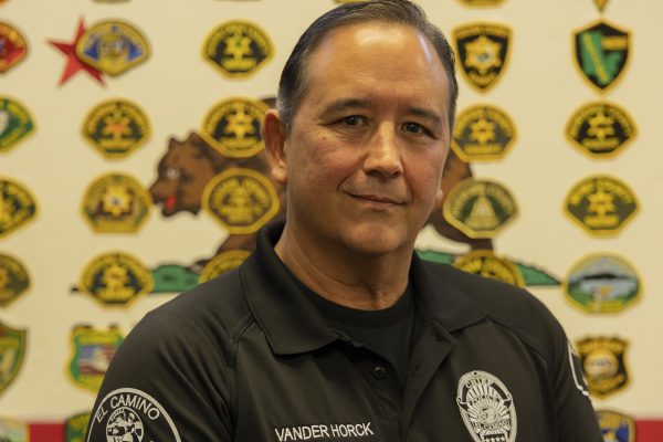 El Camino College Cheif of Police Matthew Vander Horck stands in front of his California Sheriff patch collection in his office at the ECC Police Station, on Tuesday, Nov. 4, 2025. (Oriana de Quay | The Union)