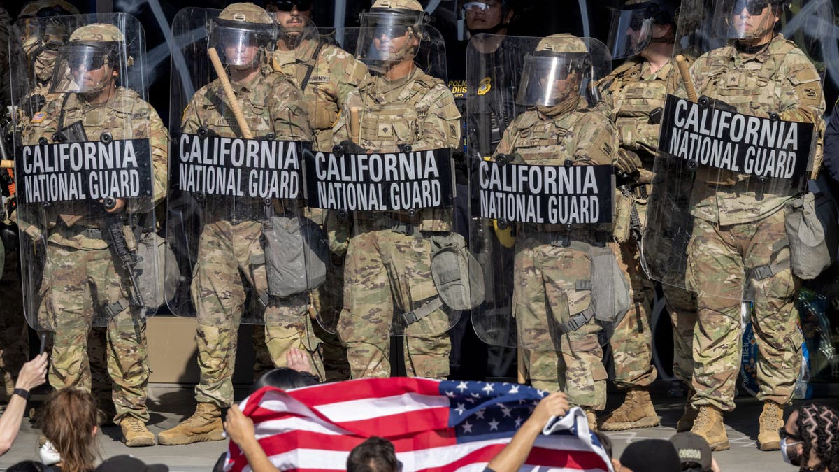 Rioters clash with California National Guard and police outside a federal building in Los Angeles during unrest sparked by federal immigration raids.
