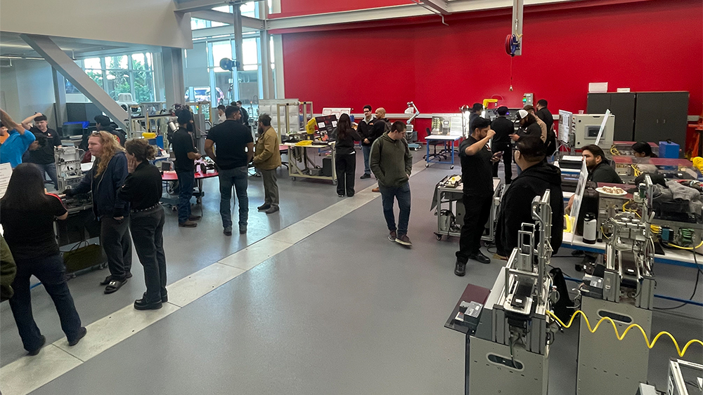 overhead shot of open house event with attendess and projects on display