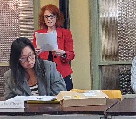 La Jolla Village Merchants Association Executive Director Jodi Rudick reads a statement at LJVMA's Feb. 18 meeting addressing allegations brought against her. (Ashley Mackin-Solomon)
