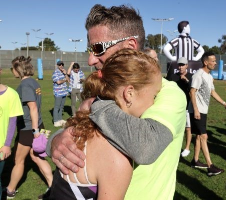 Adam Dailey hugs his daughter Chiara after she ran in the Foot Locker Cross Country National Championships in San Diego in 2023. (Hayne Palmour IV)