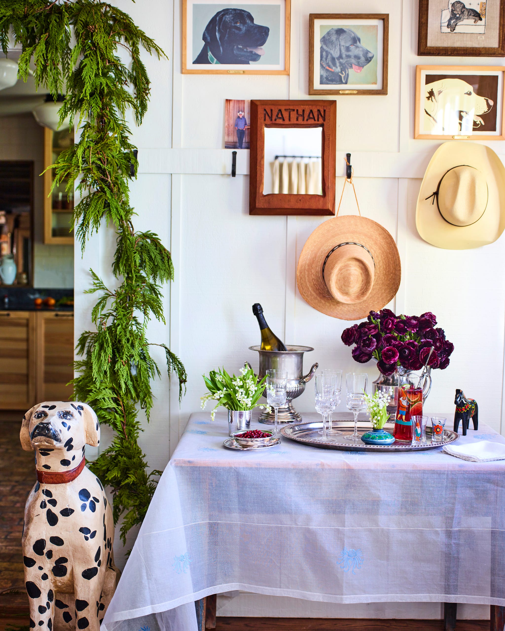 dining room with a table with a white tablecloth set iwth drink glasses and flowers