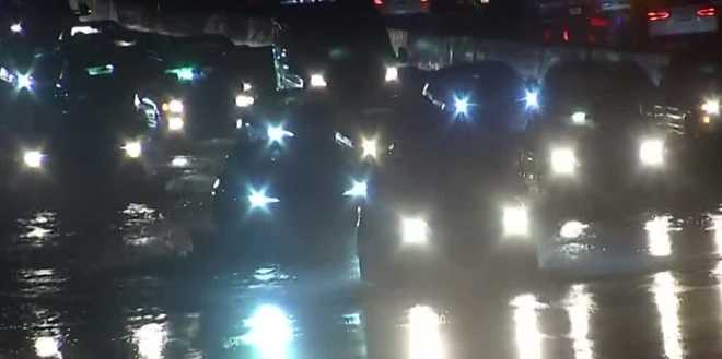 Commuters drive through flooded roadway along Interstate 80 at Norwood Avenue in the Sacramento area.