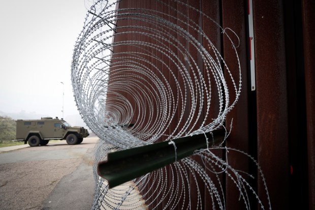 A Border Patrol security truck along the U.S.-Mexico border wall in San Ysidro on Saturday. (Sandy Huffaker / For The San Diego Union-Tribune)
