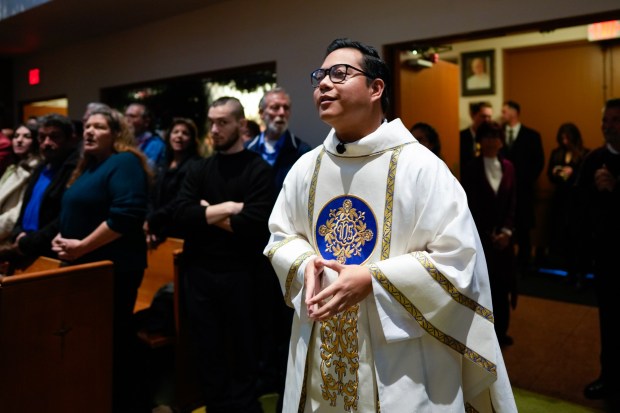 Father Brian Frulla celebrates Christmas Eve Mass at St. Therese Catholic Church in the Del Cerro Community of San Diego. Frulla is one of three men who were ordained in June and celebrated mass as new priests.  (Nelvin C. Cepeda / The San Diego Union-Tribune)