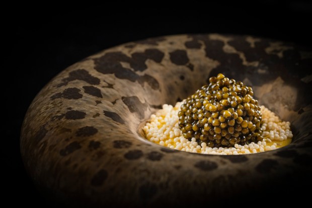 The signature dish on Addison by William Bradley's menu is nicknamed "eggs and rice." It features warm koshihikari rice, topped with smoked sabayon sauce, crispy sesame seeds and Regiis Ova Reserve caviar. (Eric Wolfinger)