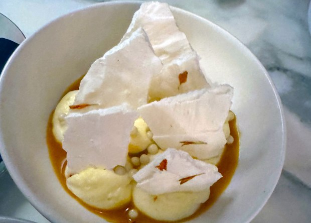 Dora Ristorante's most fabulous dessert combines Meyer lemon mousse, passionfruit sauce, shards of sweet meringue and candy pearls. (Pam Kragen / The San Diego Union-Tribune)