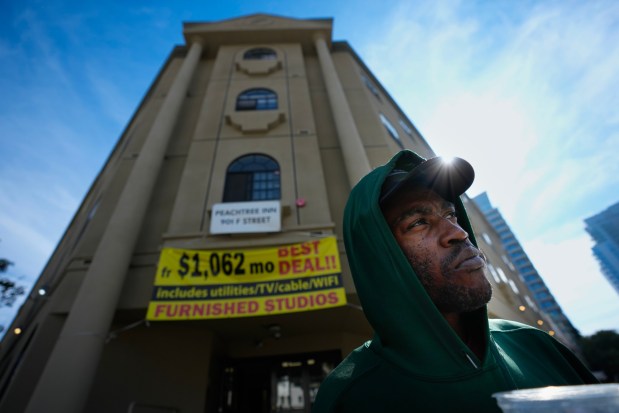 On Wednesday, Nov. 12, 2025, Dalen Harrison, 30, waits outside a downtown apartment , where he and others are give a tour of one of the transitional housing possibilities in downtown San Diego. (Nelvin C. Cepeda / The San Diego Union-Tribune)