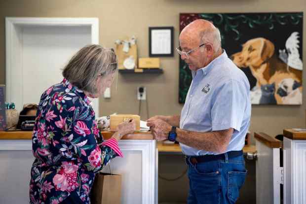 Janie Emerson receives the remains of her dog Liz from Gerry Wellman at Sorrento Valley Pet Cemetery on Thursday, Oct. 9, 2025 in San Diego, California. (Meg McLaughlin / The San Diego Union-Tribune)