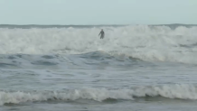 A surfer off Tourmaline Beach attempts to ride a wave, Saturday, as the ocean churns beneath him, La Jolla, Calif., December 27, 2025.