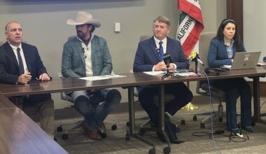 four speakers seated behind a desk