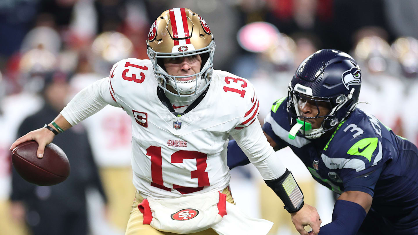 San Francisco 49ers quarterback Brock Purdy (13) is chased by Seattle Seahawks safety Nick Emmanwori (3)
