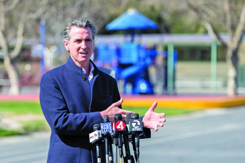 Gov. Gavin Newsom addresses reporters on new state legislation for the reopening of schools at Barron Park Elementary in Palo Alto on March 2, 2021. Photo by Magali Gauthier.