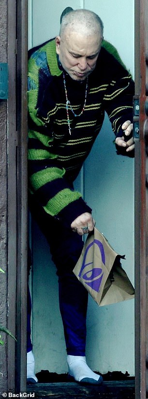 In what is a rare sighting of the star, Rourke appeared briefly from his home to pick up food dropped off at his doorstep