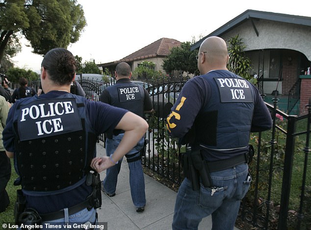 Immigration and Customs Enforcement Fugitive Operations Team members are seen during a raid in Los Angeles. When ICE were in LA, agents picked up people who had already been deported or who are criminal aliens