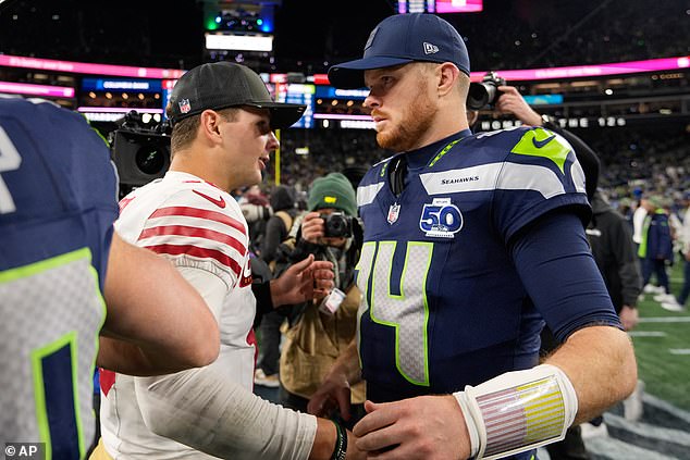 Purdy shakes hands with Seahawks quarterback Sam Darnold after Saturday's game