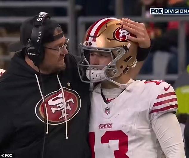 The Niners quarterback was consoled by one of the coaching staff after their playoff defeat