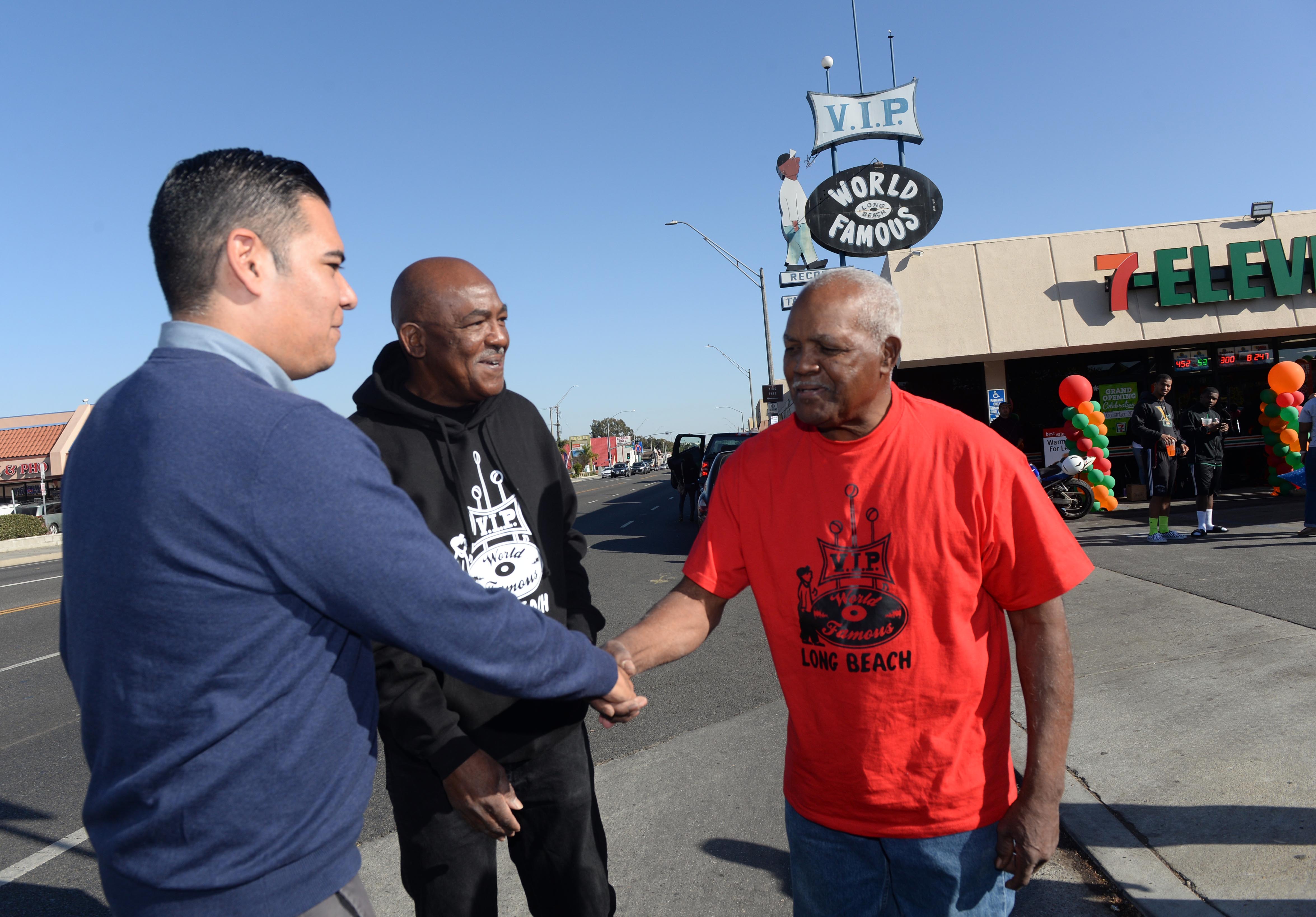 Mayor Robert Garcia,left, is presented a proclamation to brothers Kelvin...